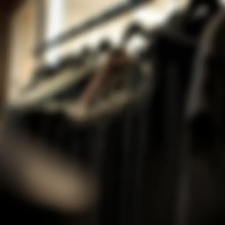 Various styles of black pants displayed on hangers