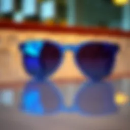 A stylish pair of blue sunglasses on a reflective surface