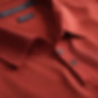 A collection of polo shirts in various colors, focusing on the red one.