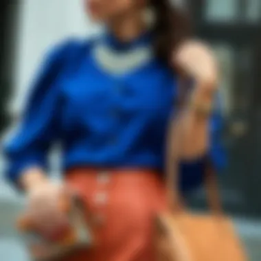 Elegant styling of cobalt blue blouse paired with chic accessories.