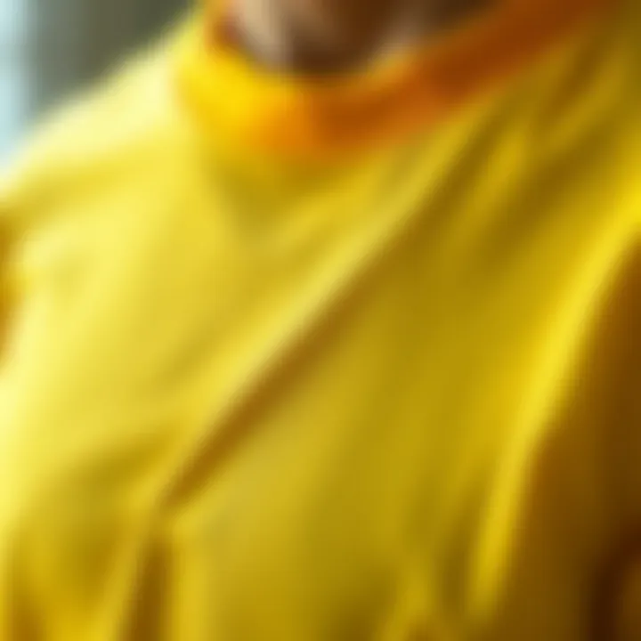 Close-up of the fabric used in yellow collared t-shirts, highlighting texture and quality.