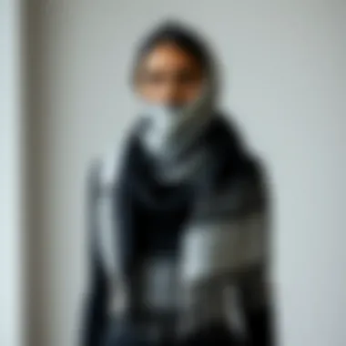 Stylish black and white shawl showcased against a minimalist background